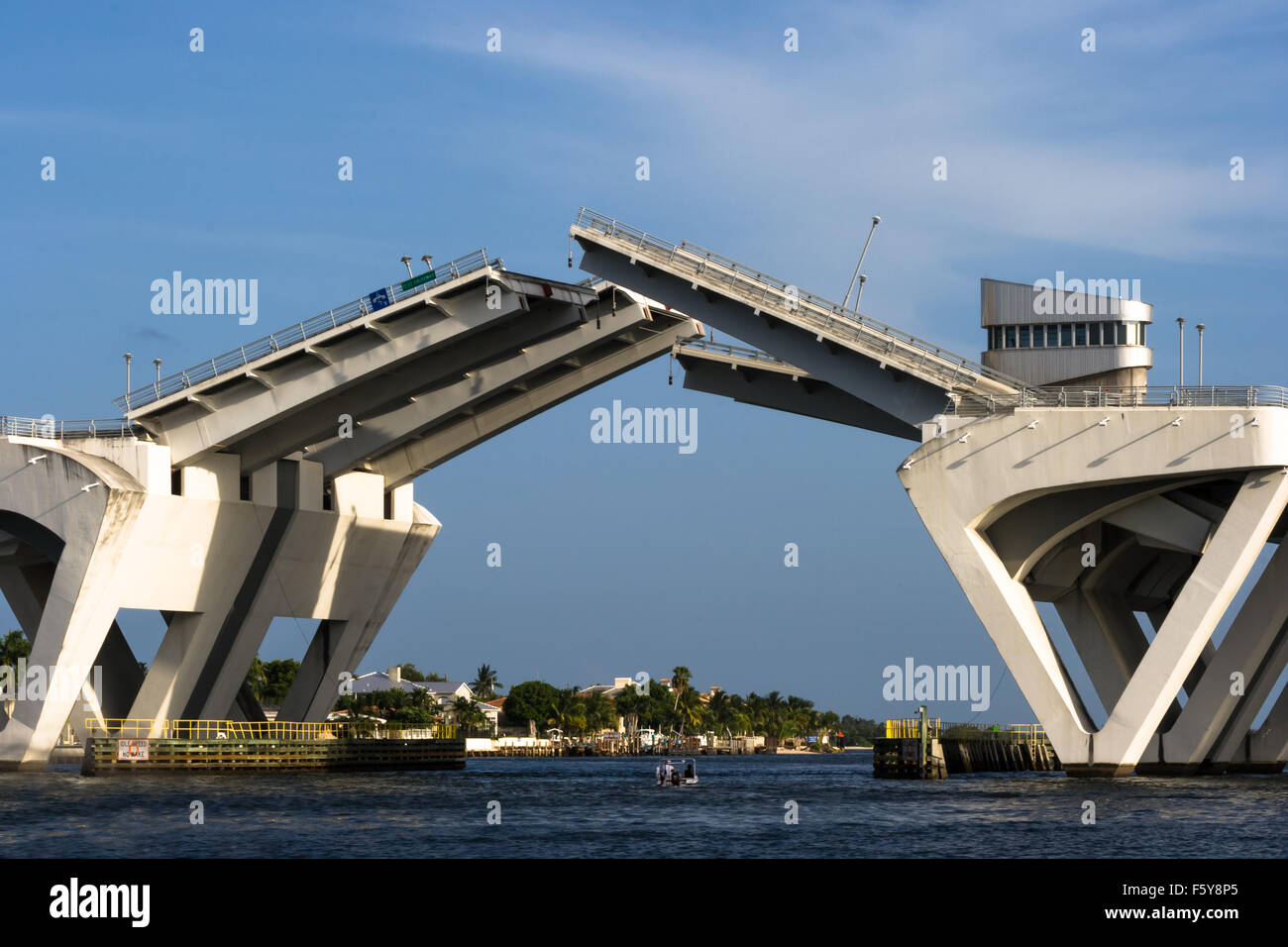 A small boat goes under the 17th Street bascule bridge in Fort Lauderdale as it heads south on the Intracoastal toward Dania. Stock Photo