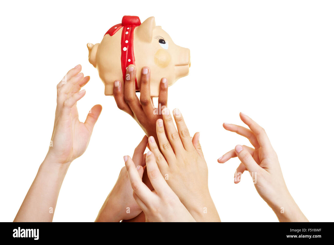 Many desperate hands reaching for a piggy bank Stock Photo
