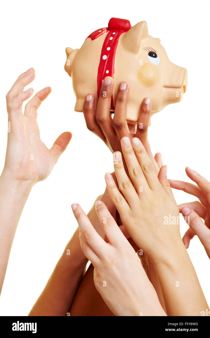 Many desperate hands reaching for a piggy bank Stock Photo