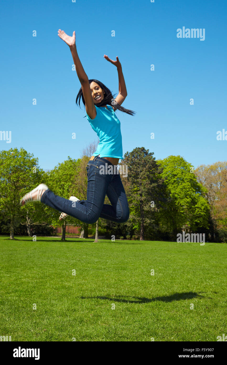 Young african woman jumping into the air Stock Photo - Alamy