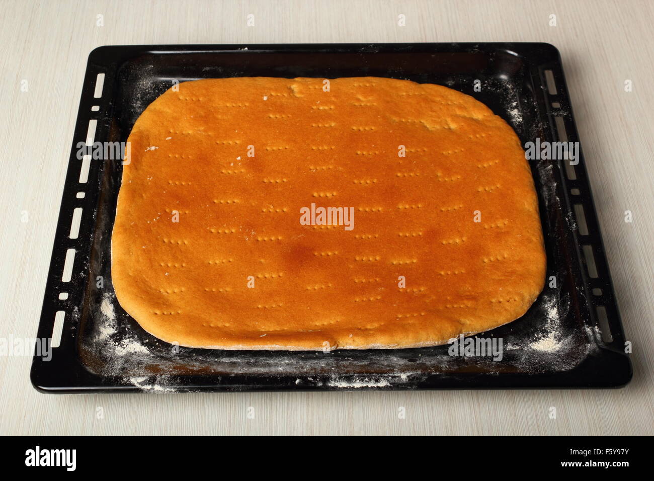 Freshly baked flatbread in baking sheet. Making Flatbread. Stock Photo