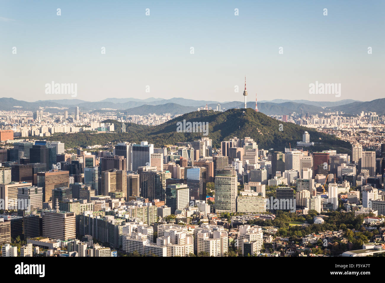 An aerial view of Seoul, South Korea capital city with the Namsan mountain in the middle of the city business district. Stock Photo
