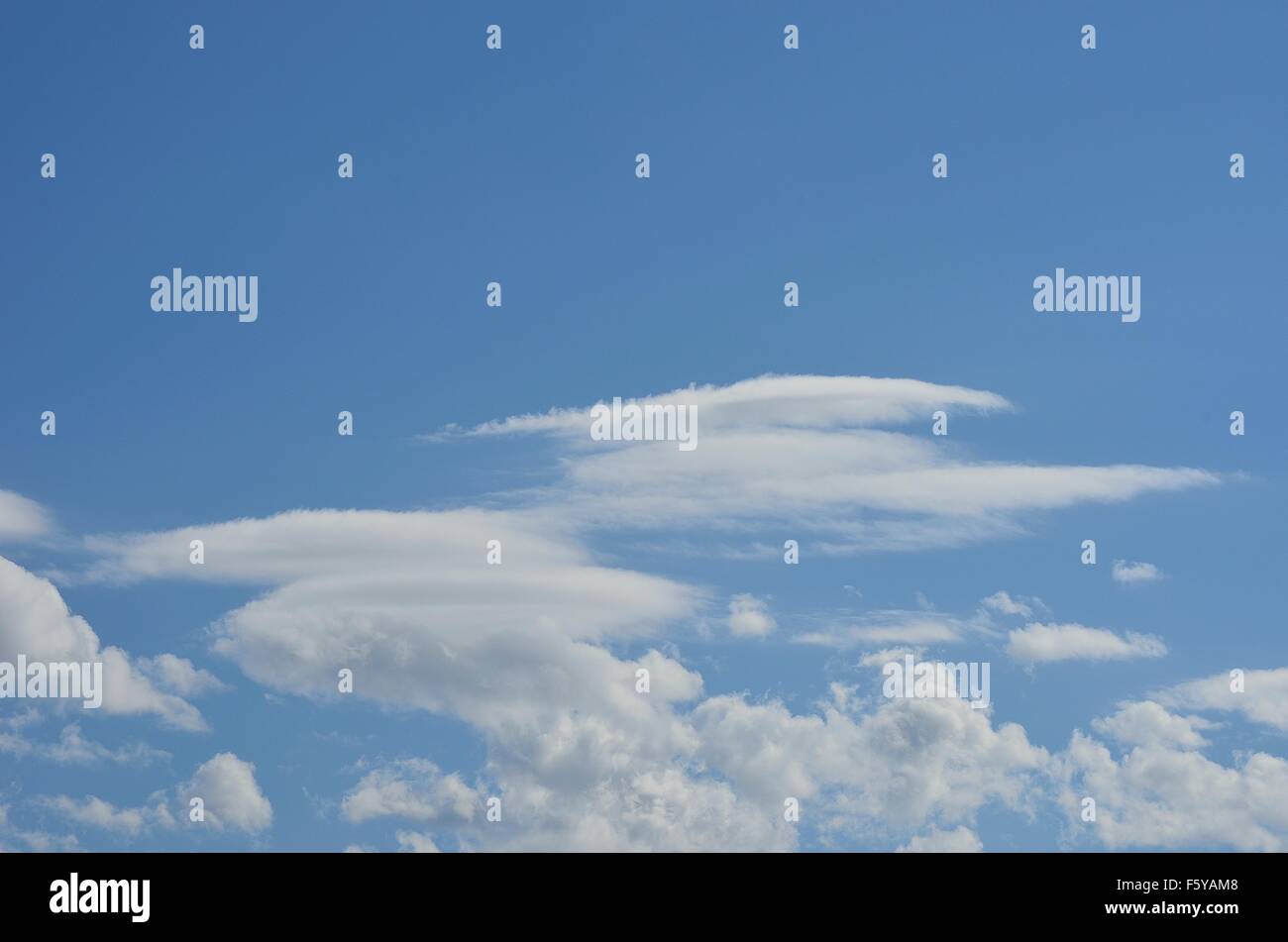 vibrant blue sky with fluffy white clouds in summer sunlight Stock ...
