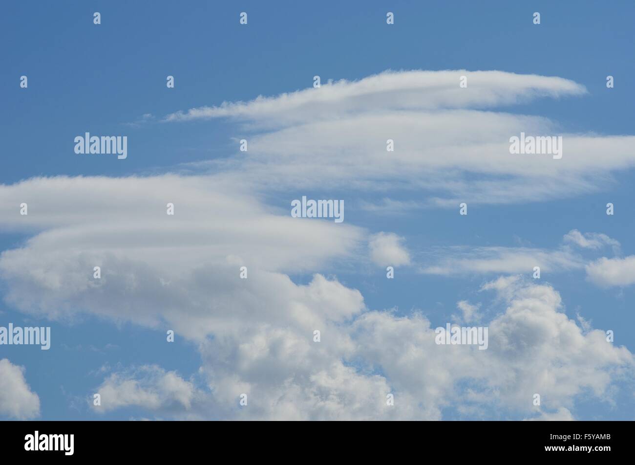 vibrant blue sky with fluffy white clouds in summer sunlight Stock ...