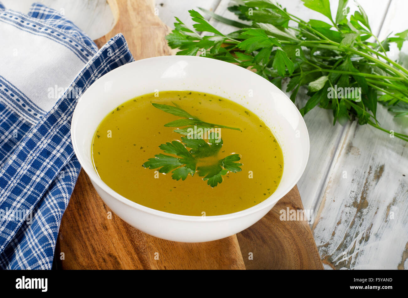 Bowl of broth on wooden table. Selective focus Stock Photo