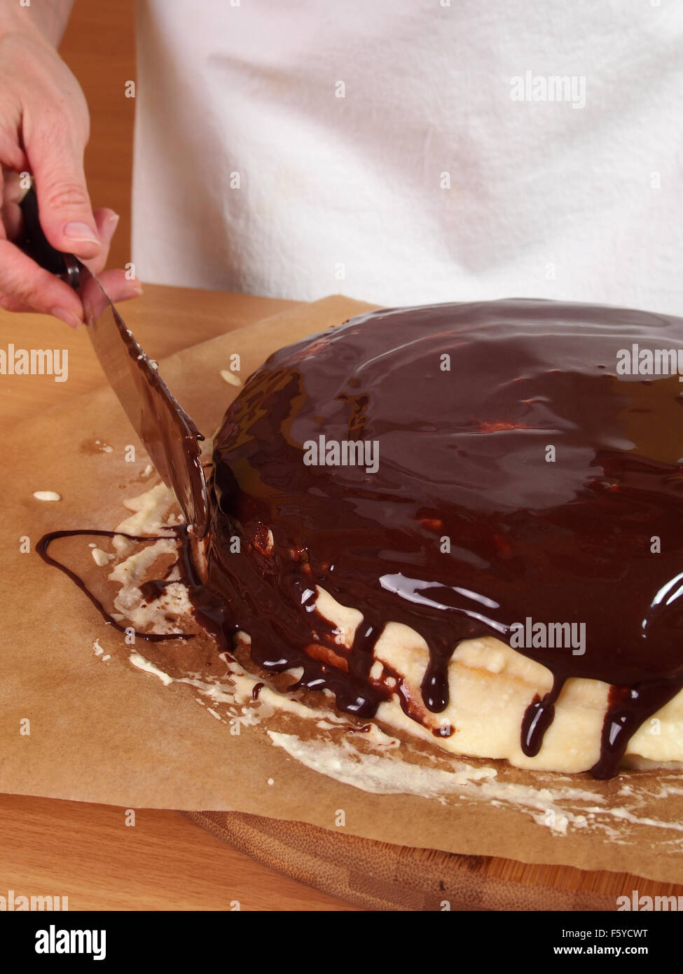 Frosting and icing layers. Making Chocolate Layer Cake with Cream Cheese Filling and Chocolate Topping. Series. Stock Photo