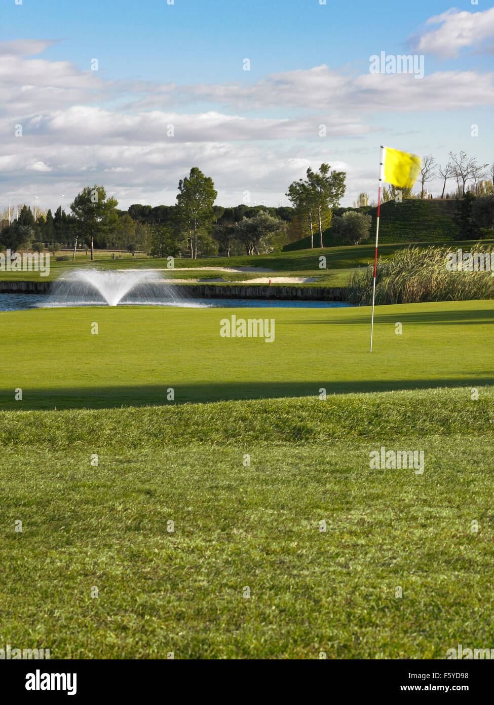 Golf green landscape with fountain in a lake vertical Stock Photo Alamy