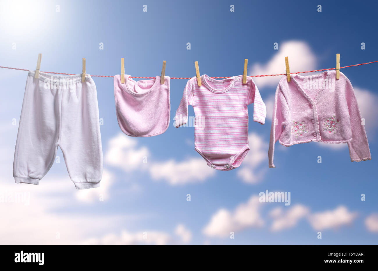 Clean baby girl clothes on the outdoor clothesline Stock Photo
