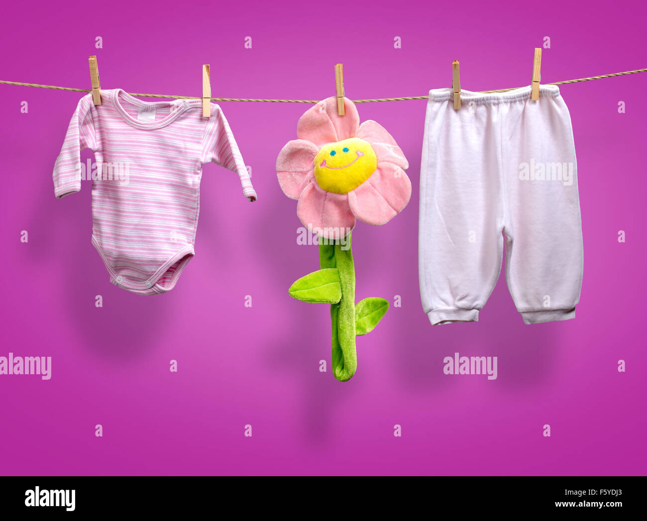Baby girl y clothes   on the clothesline Stock Photo
