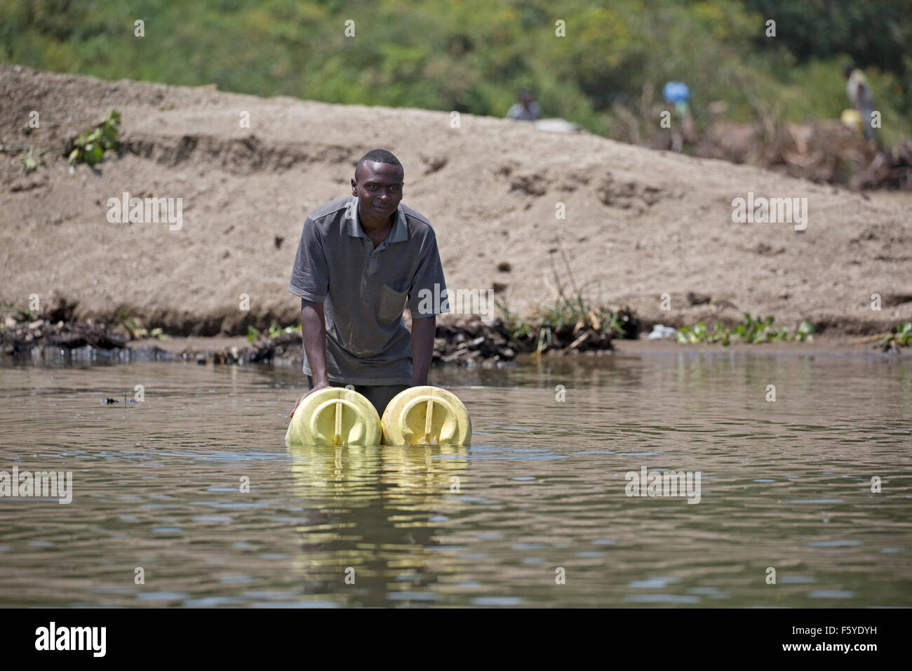African man collecting water from  Lake Naivasha Kenya Stock Photo