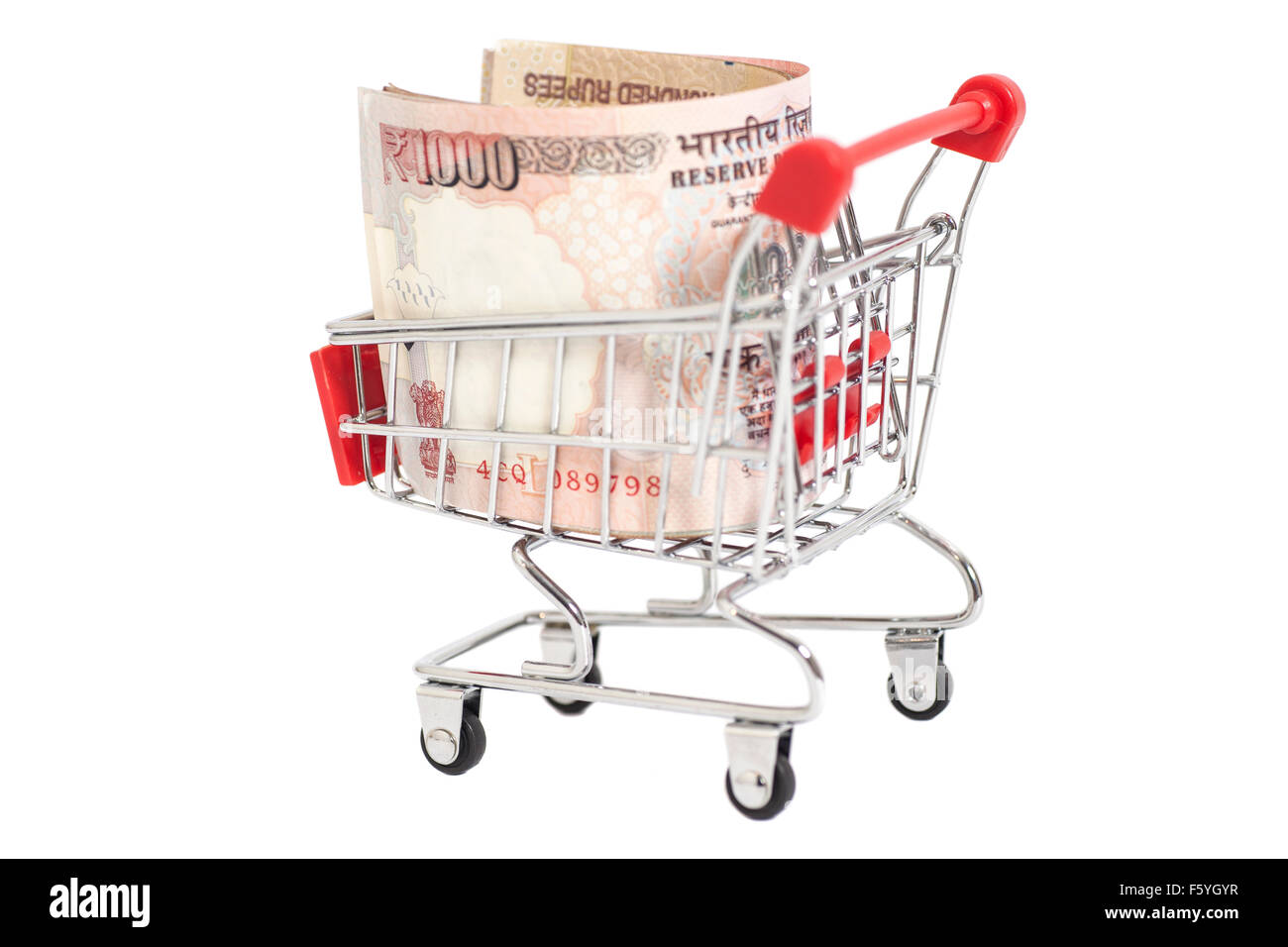 Indian 1000 rupees in shopping cart isolated on white background Stock Photo