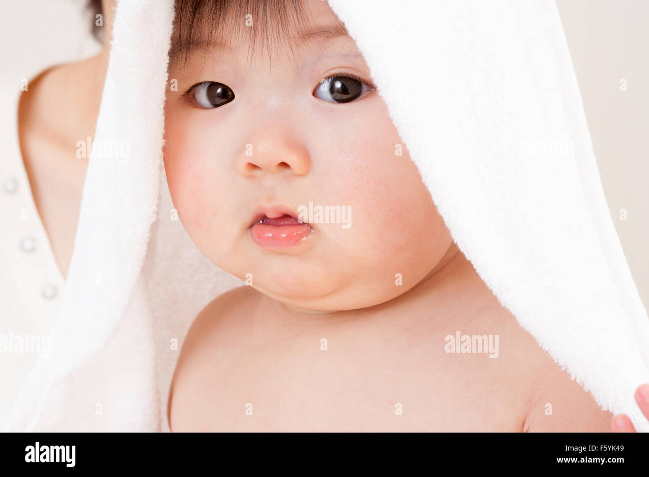 Cute asian baby looking at the camera with a towel over his head Stock  Photo - Alamy