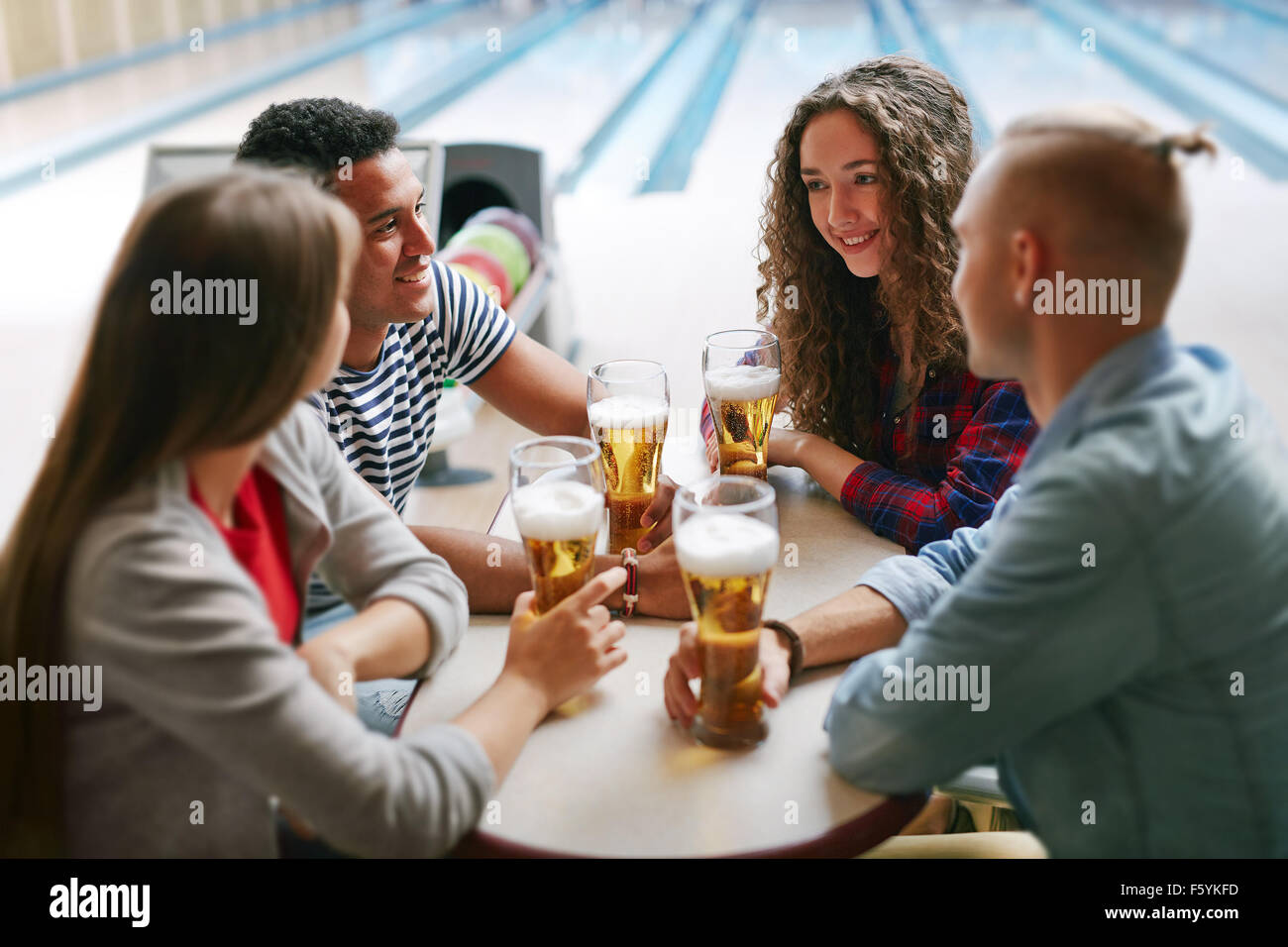 Group of friends drinking beer in bowling club Stock Photo