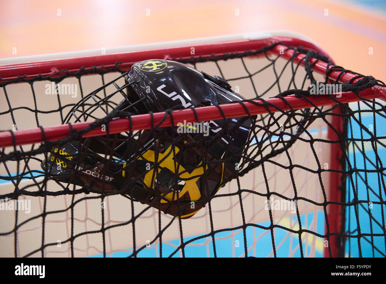 Children boys schoolchildren playing floorball (floor hockey) match in