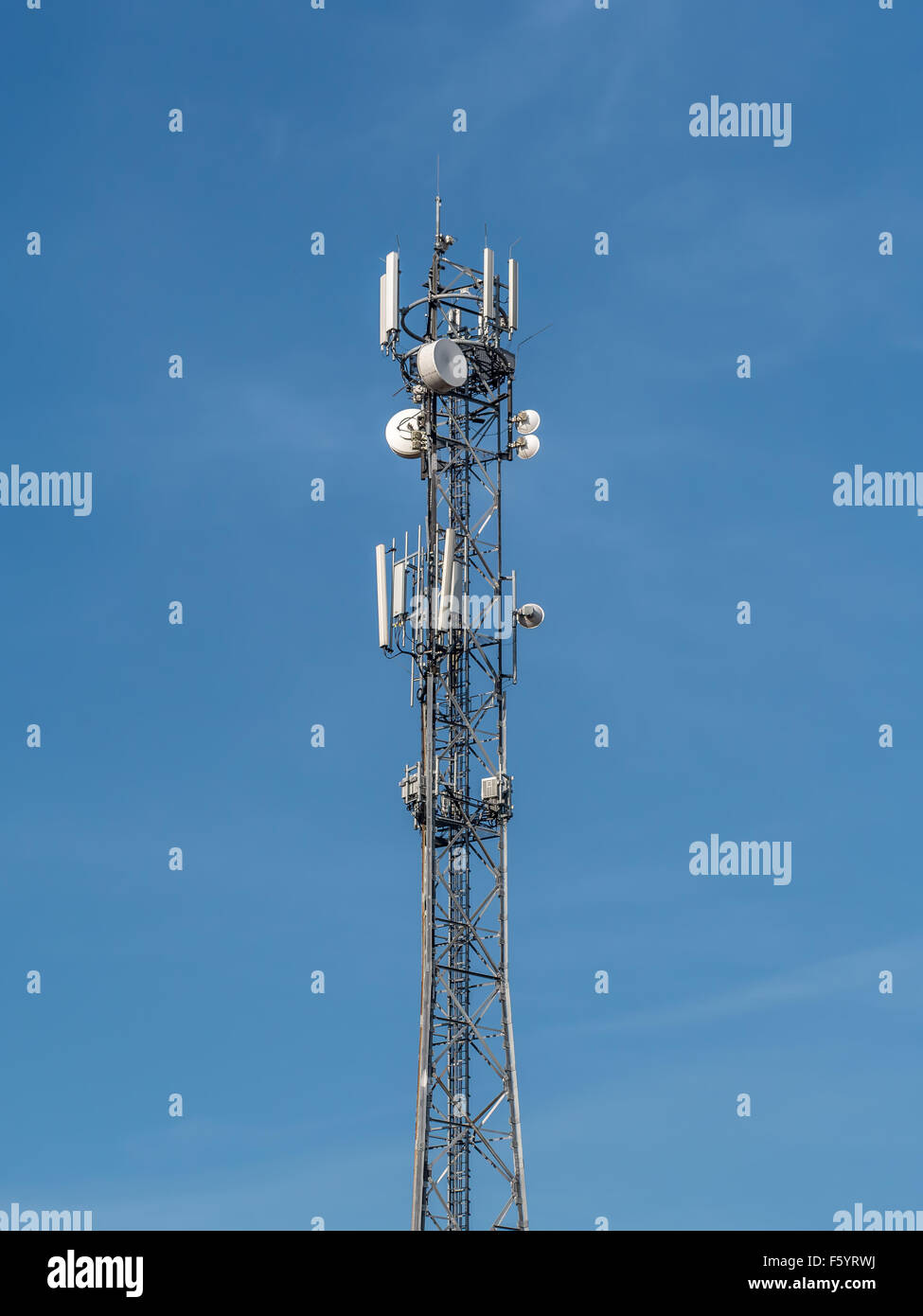 Telecommunications tower over blue sky Stock Photo