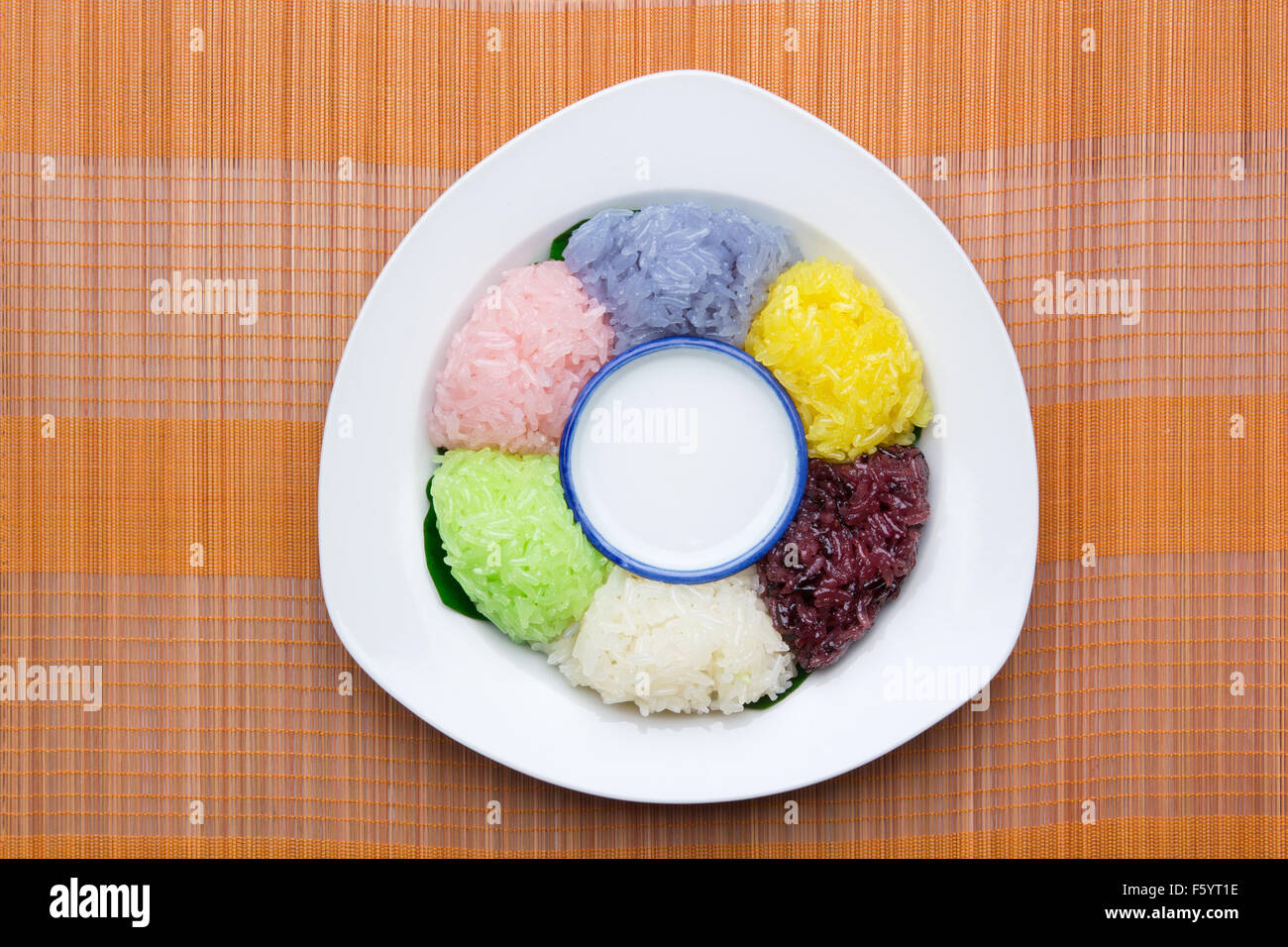 dessert sweet sticky rice with coconut milk in plate on wood pattern background Stock Photo