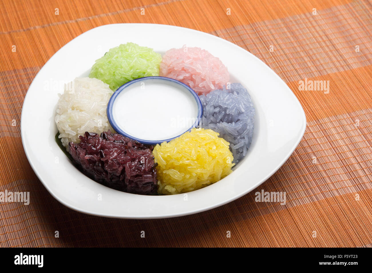dessert sweet sticky rice with coconut milk in plate on wood pattern background Stock Photo