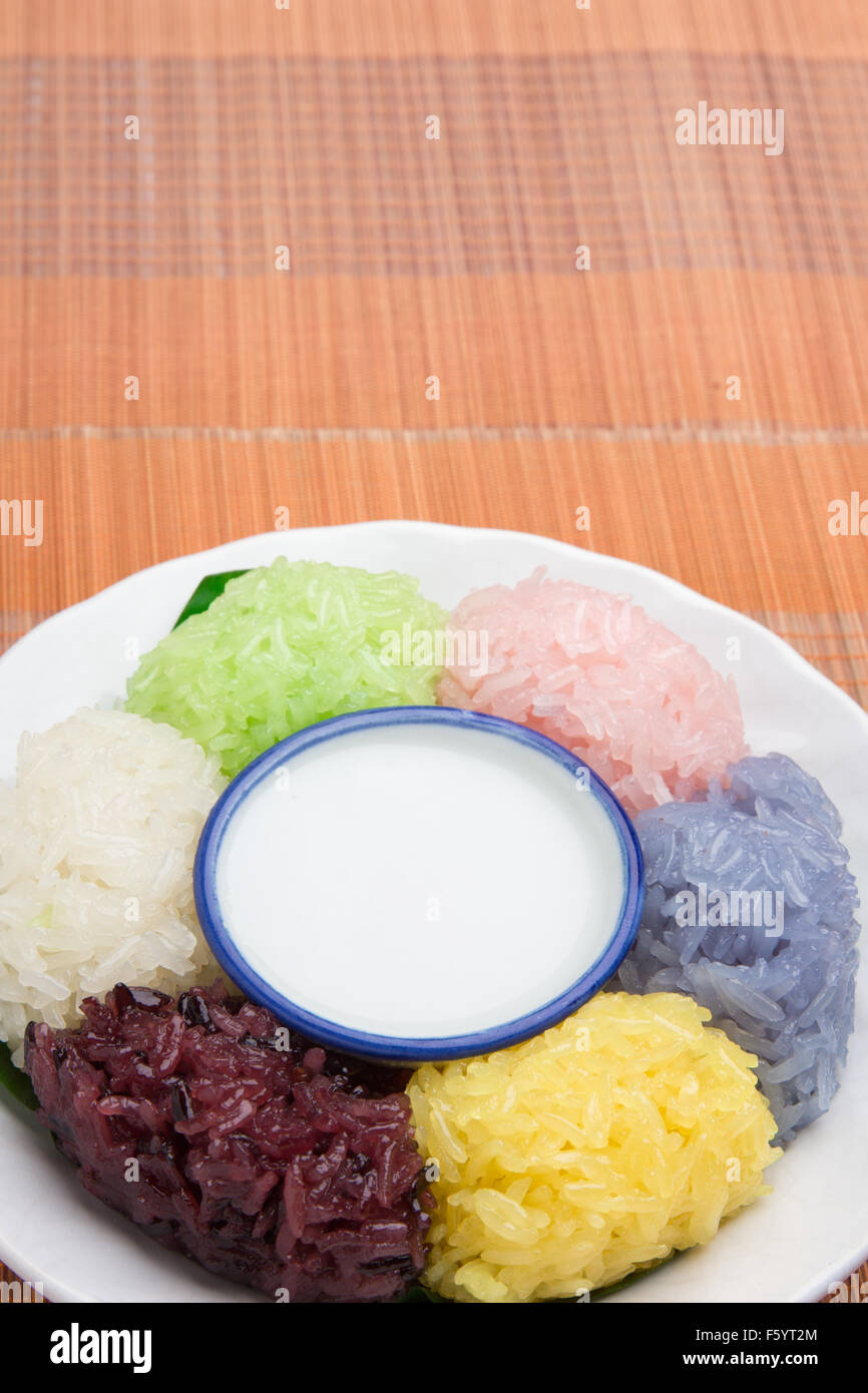 dessert sweet sticky rice with coconut milk in plate on wood pattern background Stock Photo