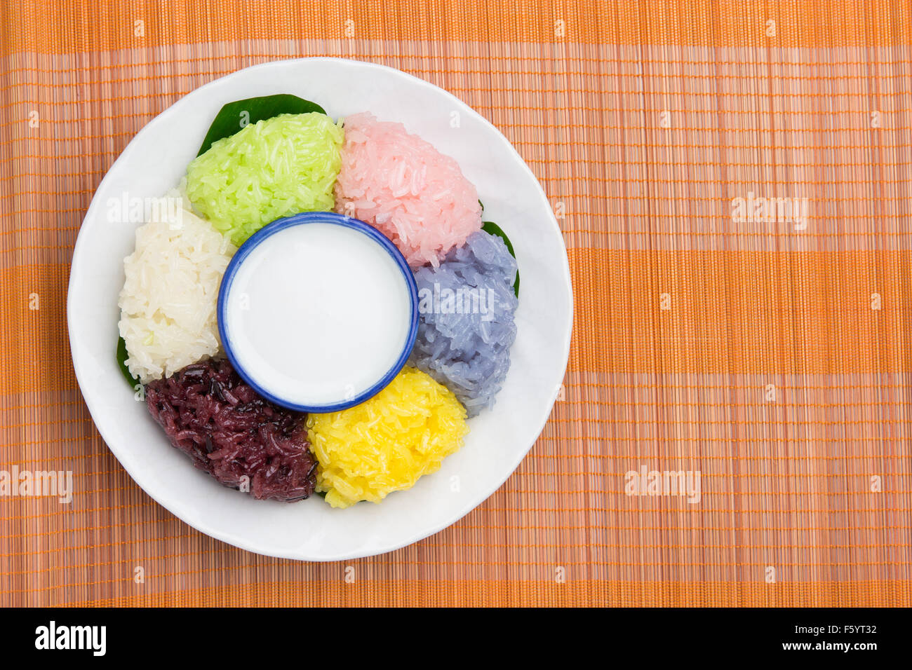 dessert sweet sticky rice with coconut milk in plate on wood pattern background Stock Photo