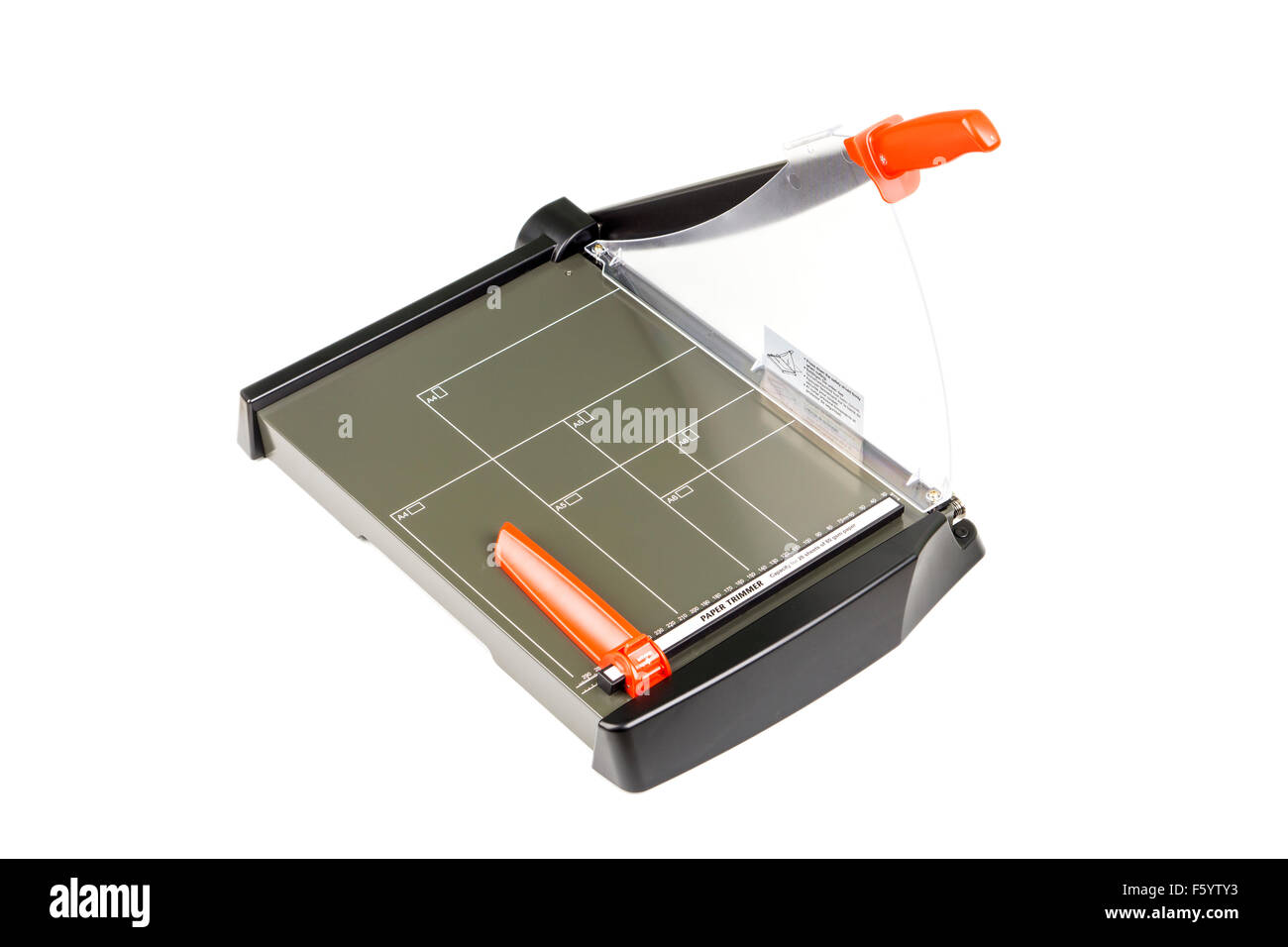 Paper trimmer with safety shield on white background. Stock Photo