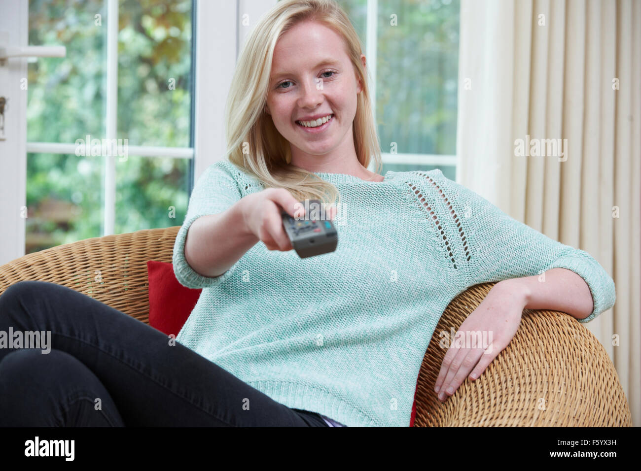Teenage Girl Relaxing And Watching TV At Home Stock Photo Alamy