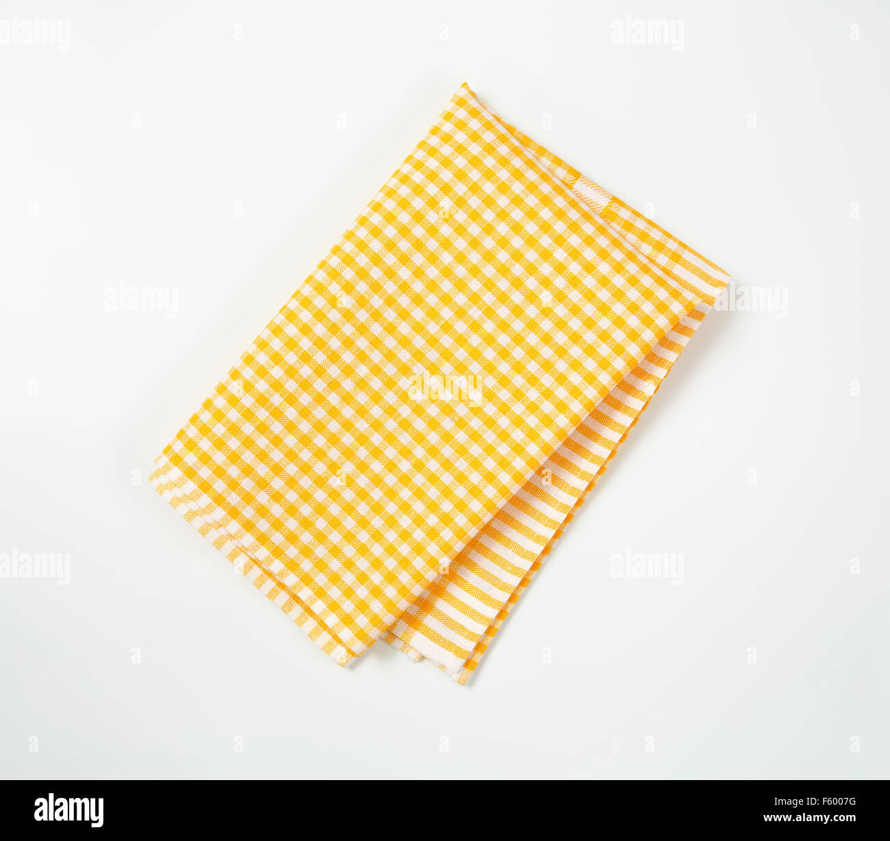 yellow and white checkered tablecloth on white background Stock Photo