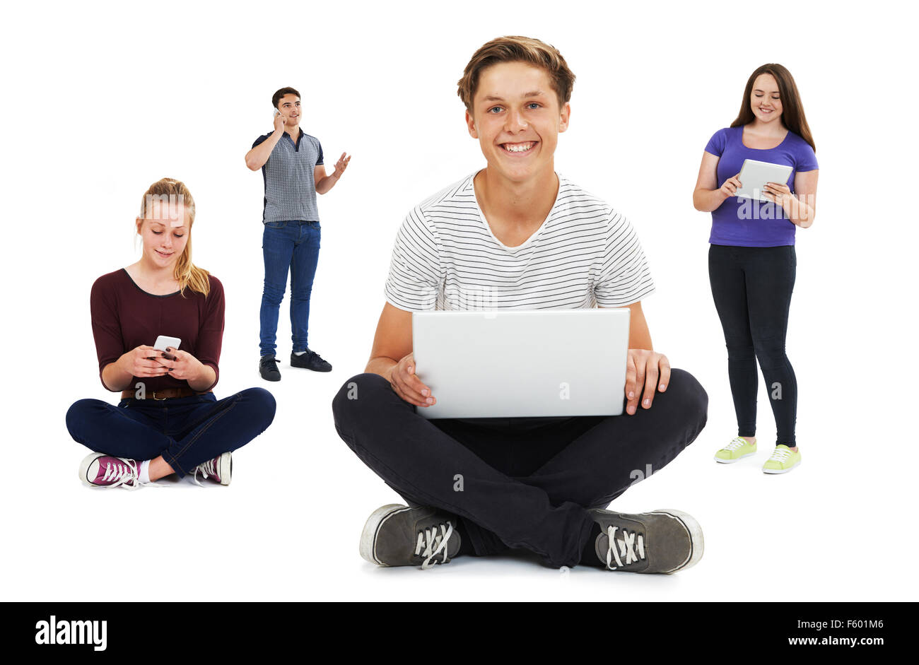 Studio Shot Of Teenagers Using Communication Technology Stock Photo