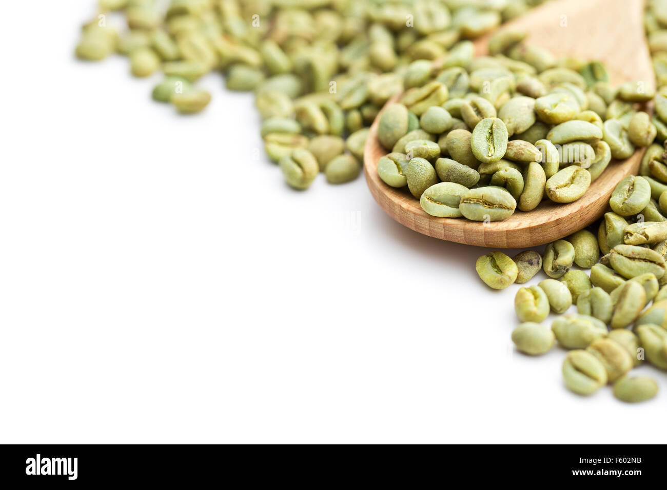 green coffee beans in wooden spoon on white background Stock Photo - Alamy