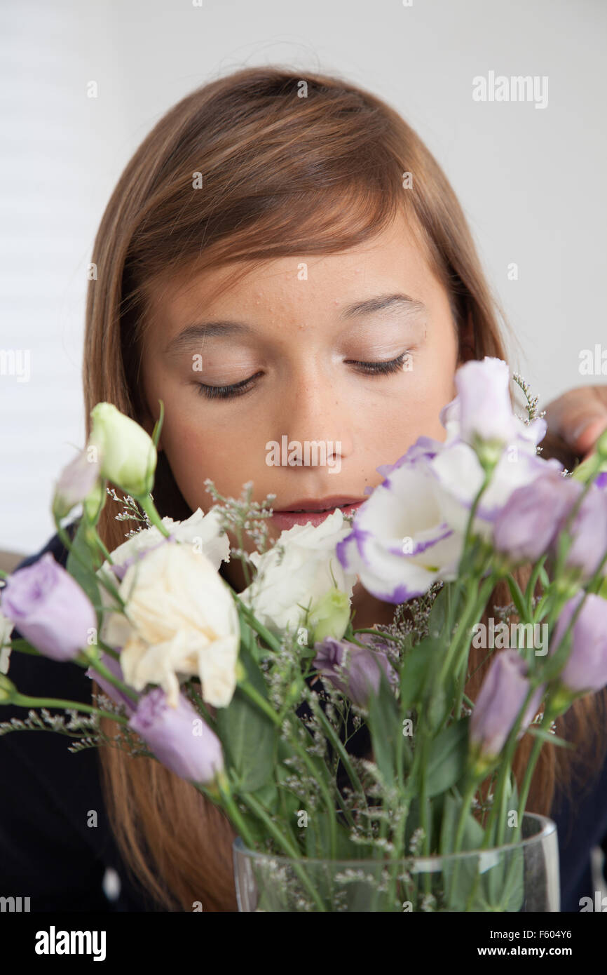 Pretty girl smelling the flowers Stock Photo - Alamy