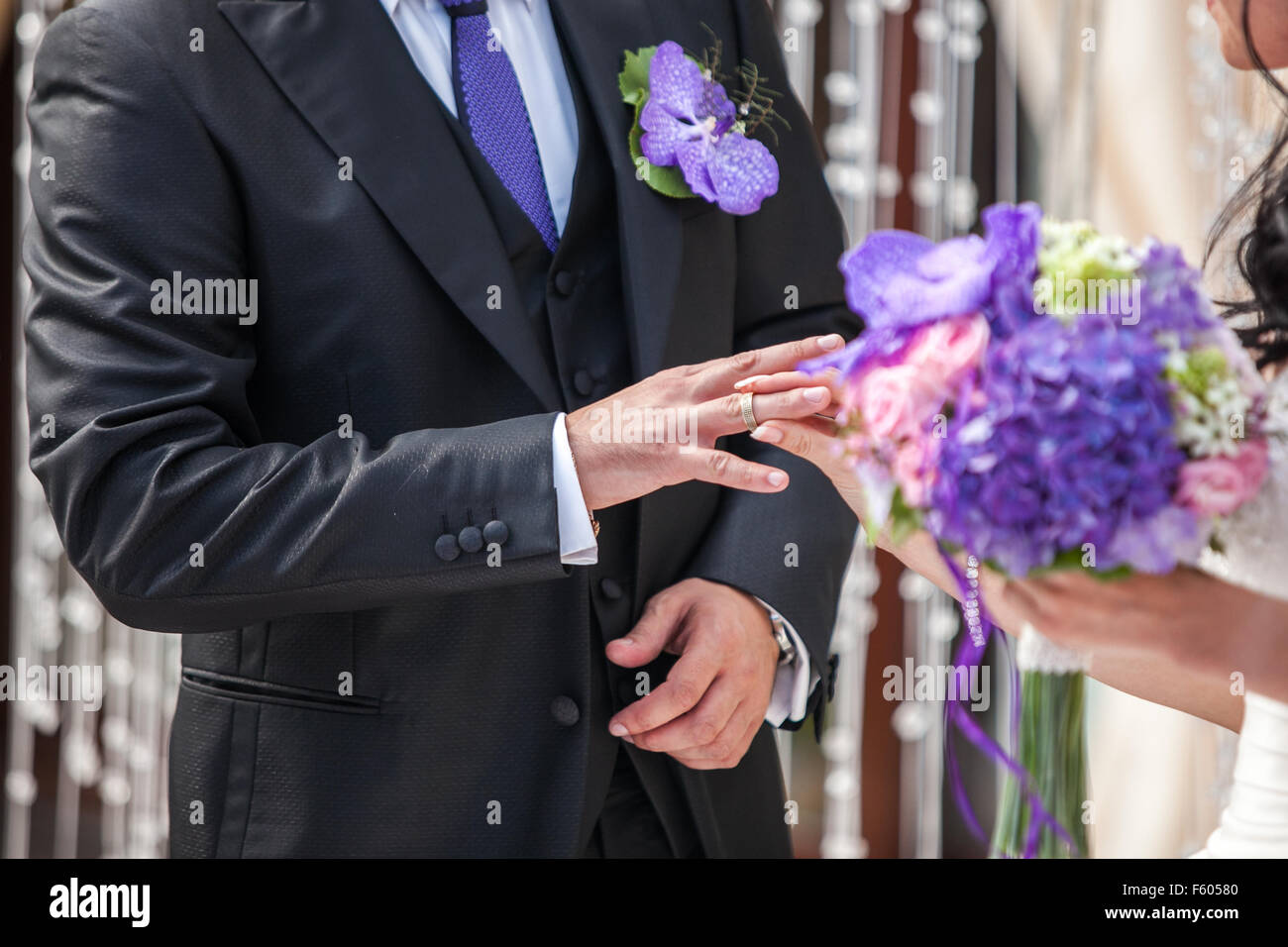 groom wears the ring bride during the wedding Stock Photo - Alamy