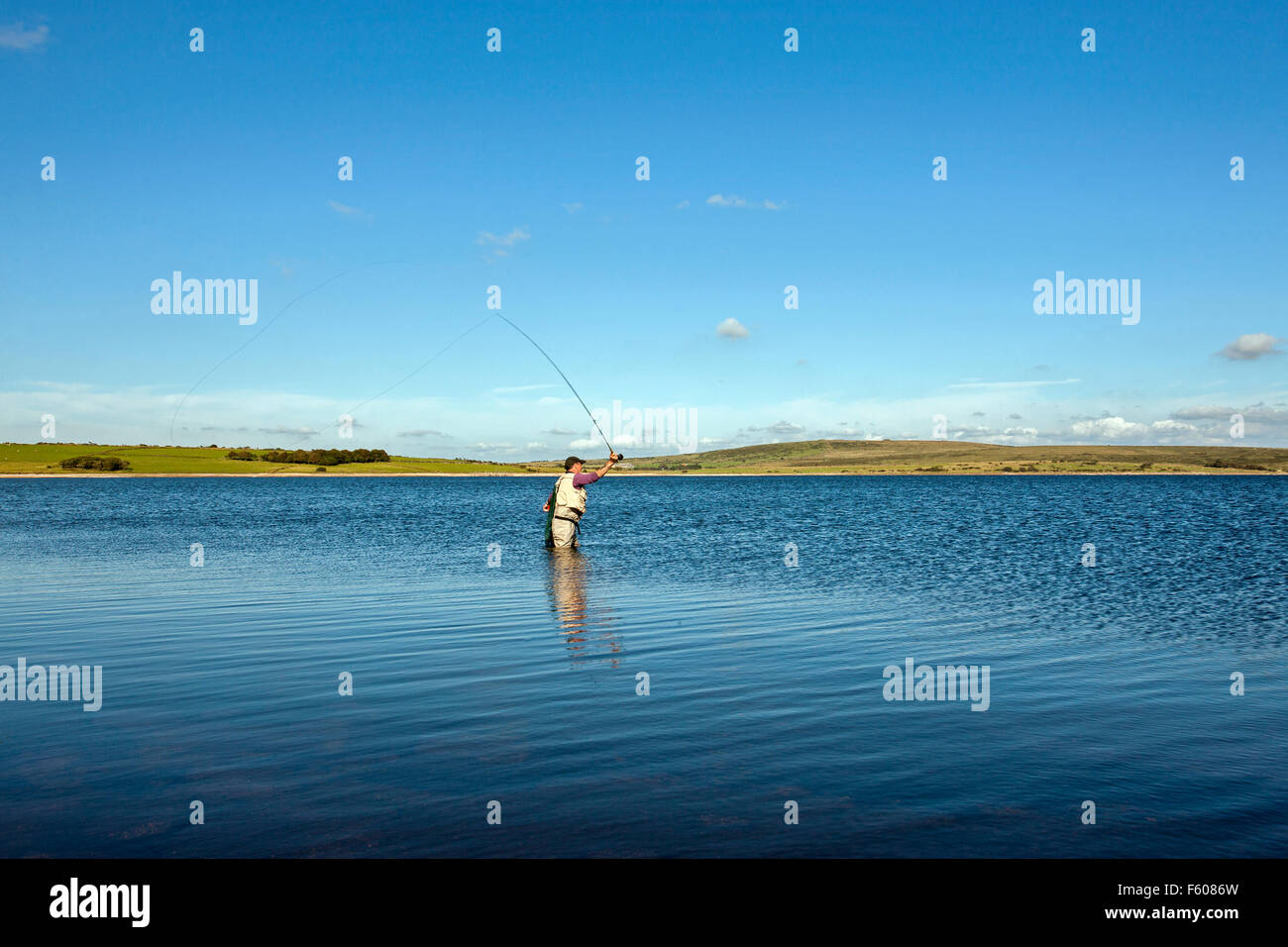 fly fishing on Colliford reservoir lake Bodmin Moor Cornwall lone man