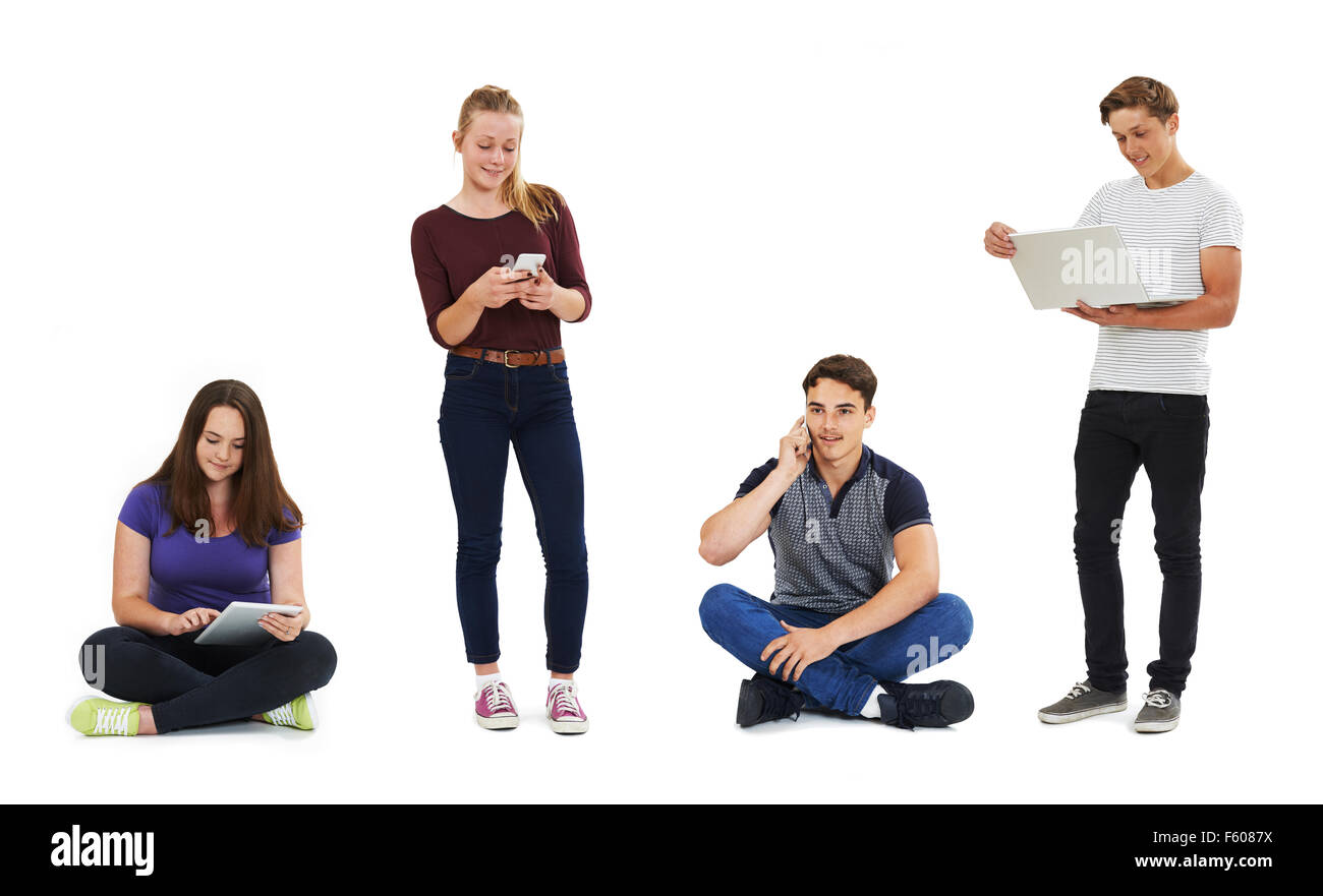 Studio Shot Of Teenagers Using Communication Technology Stock Photo
