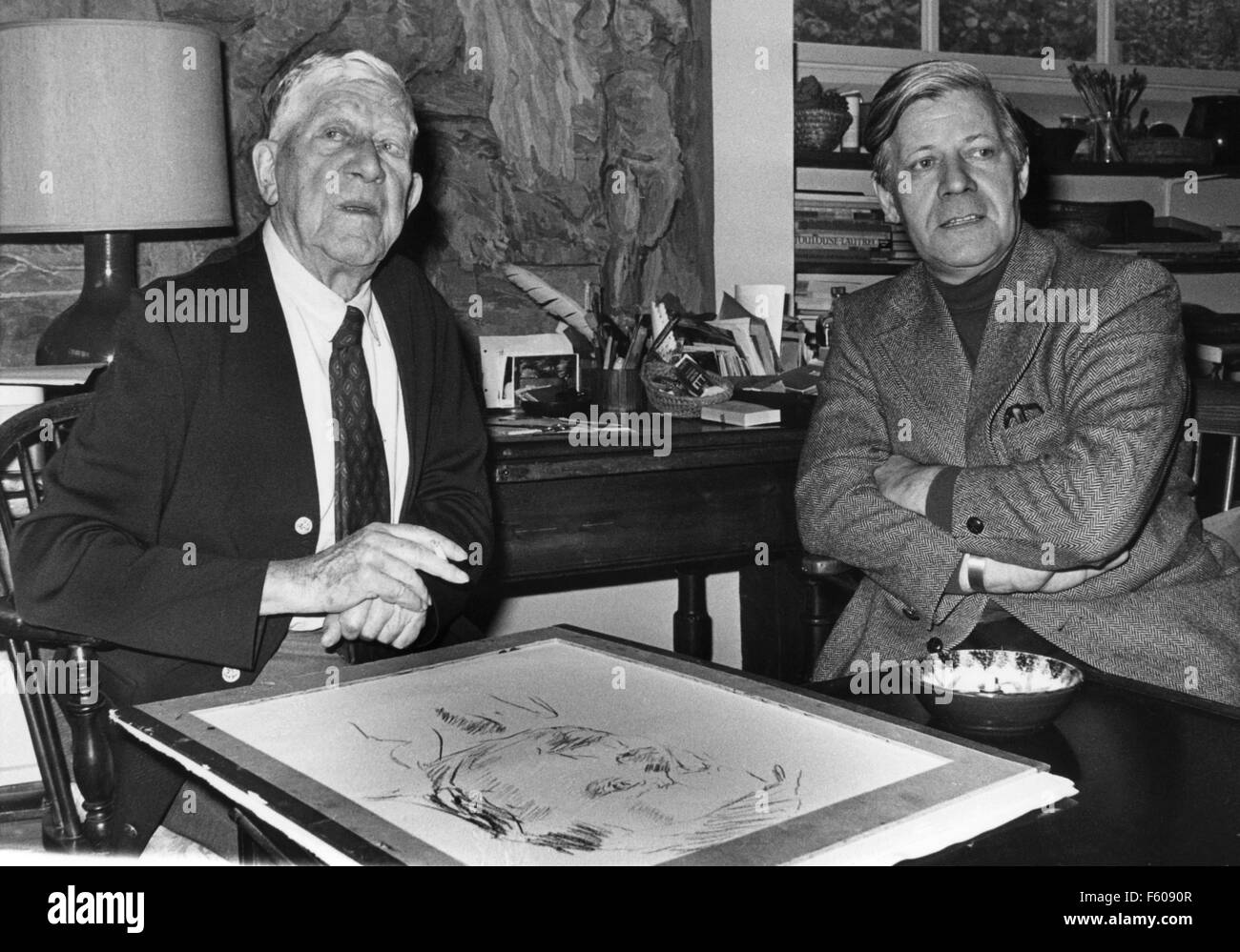 Artist Oskar Kokoschka (L) is sitting together with Chancellor Helmut Schmidt at his home in Villeneuve on 29 October 1976. A portrait sketch of the Chancellor is lying in front of them. Stock Photo