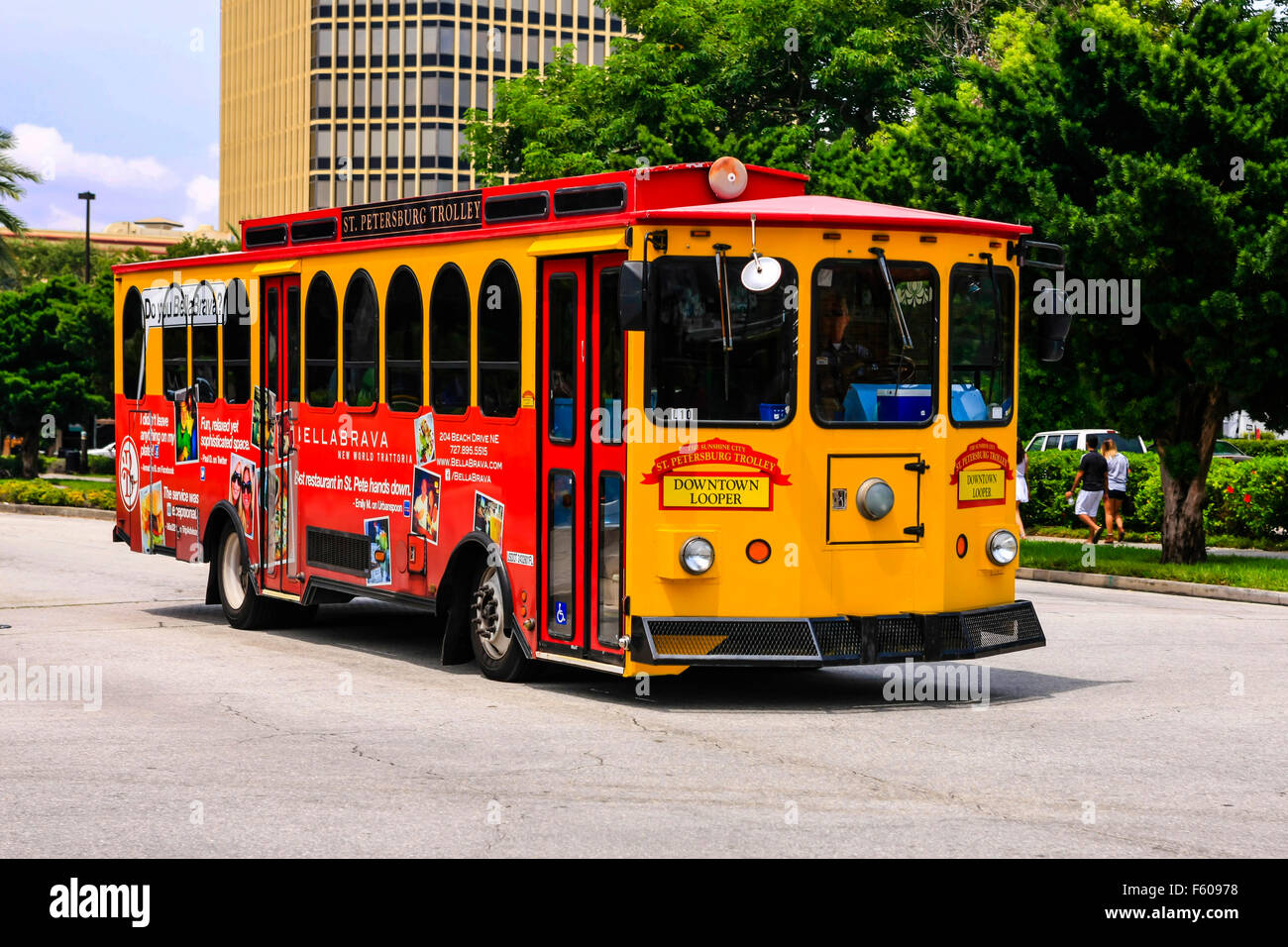 The bright yellow and red downtown Looper bus that tours St. Petersburg,  Florida Stock Photo - Alamy