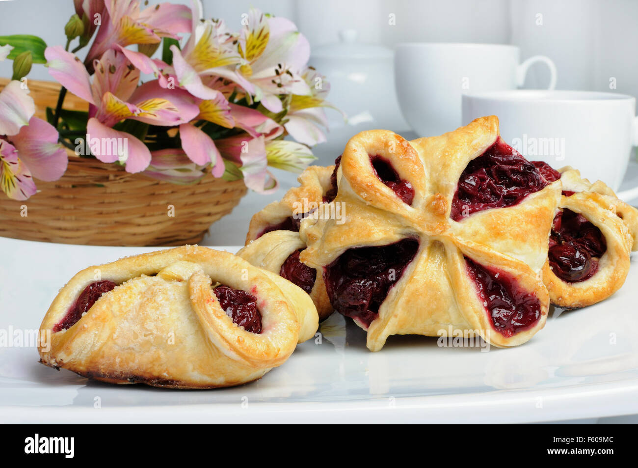 Bun puff pastry stuffed with cherries Stock Photo