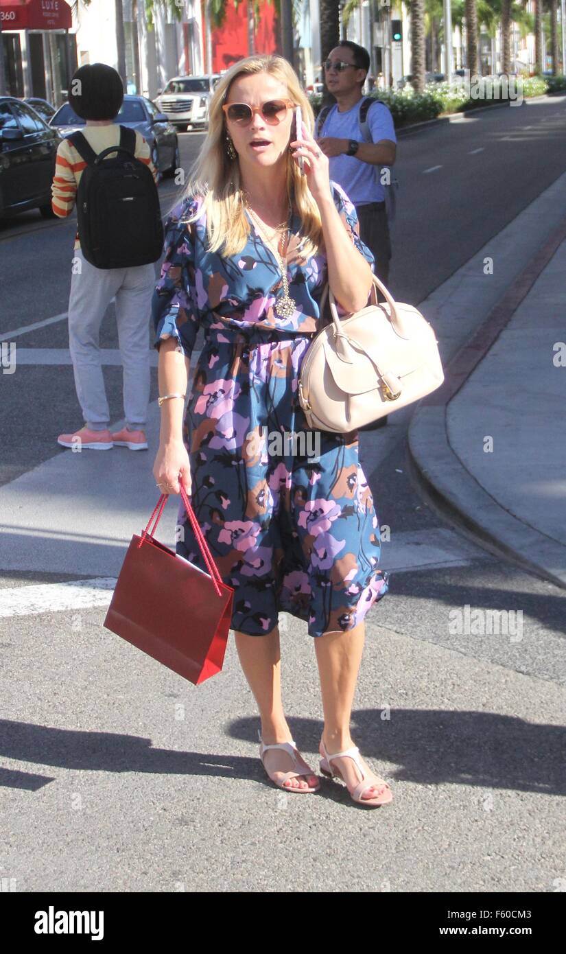 Reese Witherspoon wearing a blue floral dress goes shopping at Cartier ...