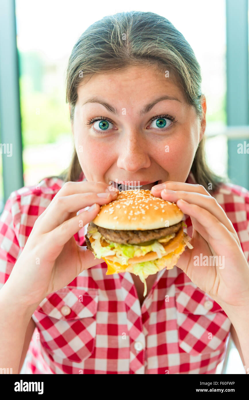 Hungry girl holding hands a hamburger Stock Photo