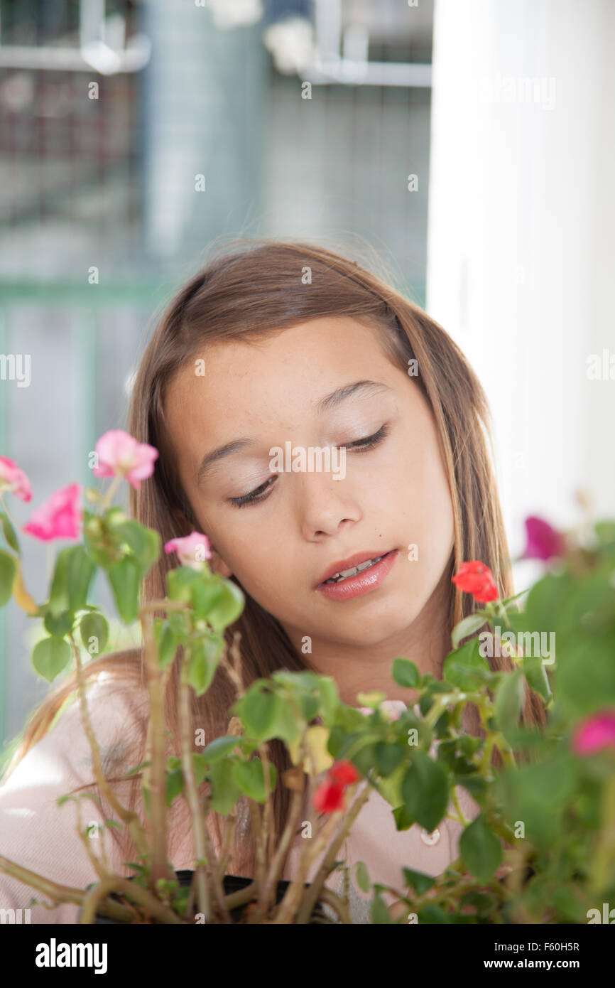 Young girl smelling the flowers Stock Photo - Alamy