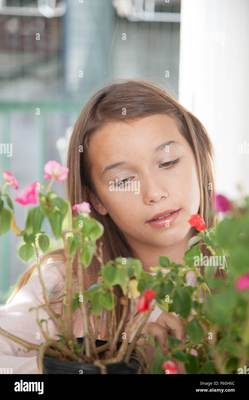 Young girl smelling the flowers Stock Photo - Alamy