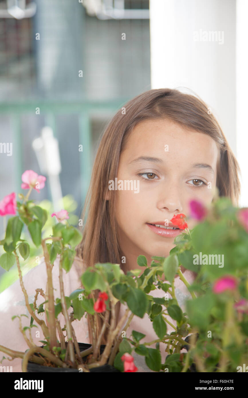 Young girl smelling the flowers Stock Photo - Alamy
