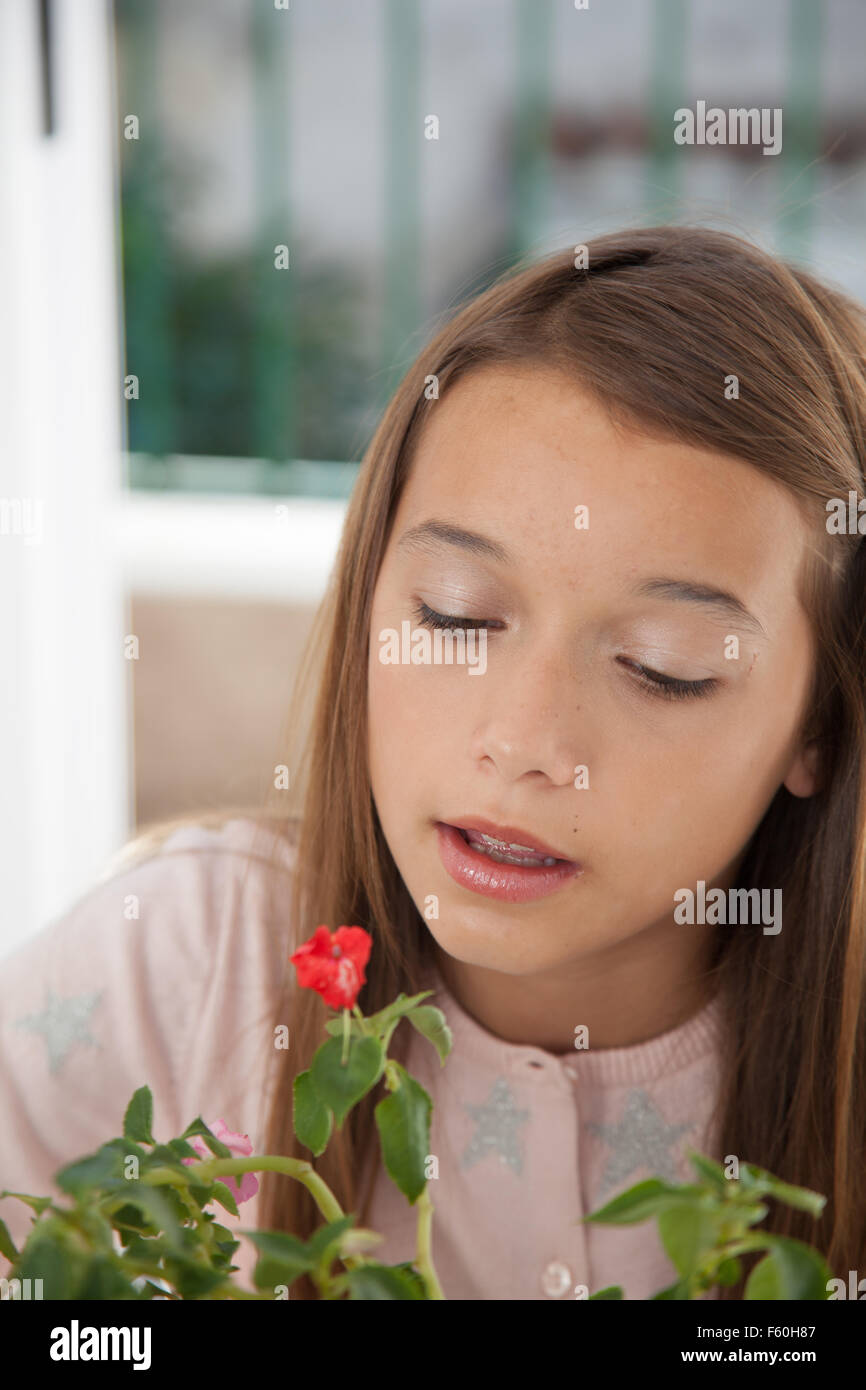Young girl smelling the flowers Stock Photo - Alamy