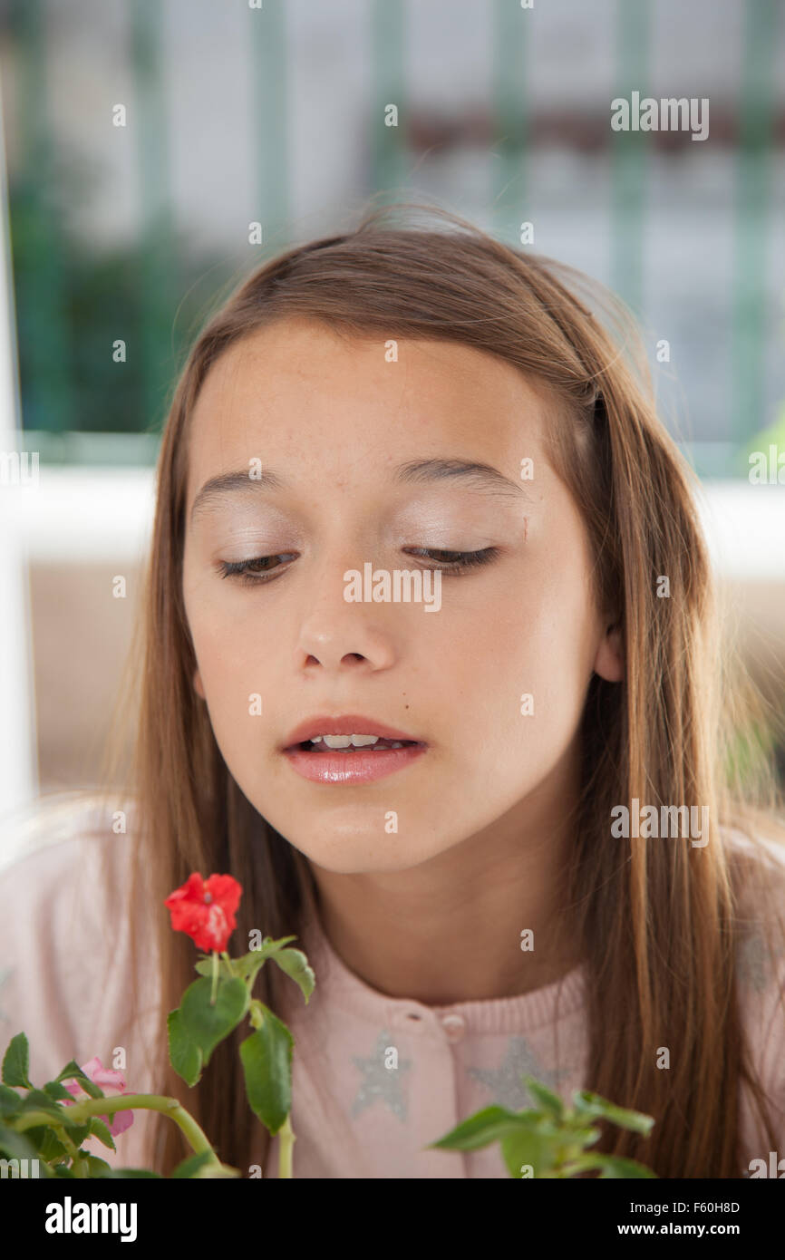 Young girl smelling the flowers Stock Photo - Alamy