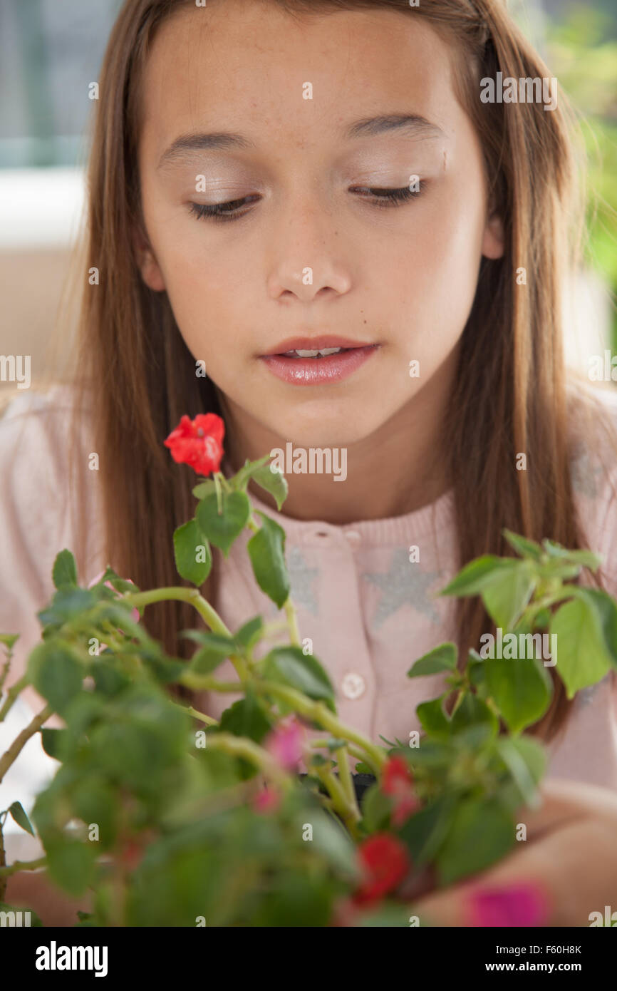 Young girl smelling the flowers Stock Photo - Alamy