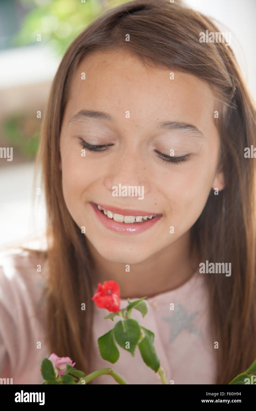 Young girl smelling the flowers Stock Photo - Alamy