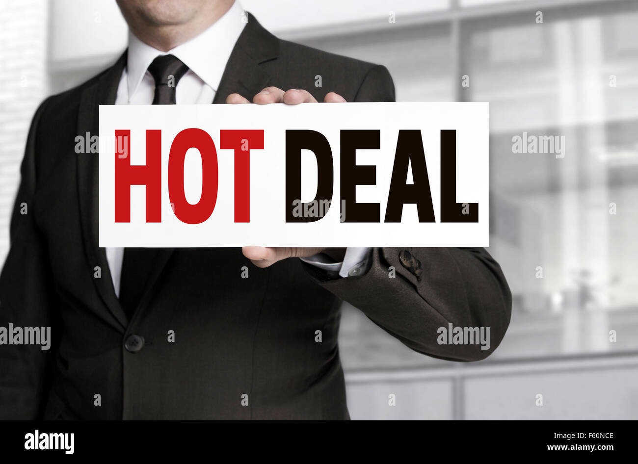 Hot Deal sign is held by businessman concept. Stock Photo