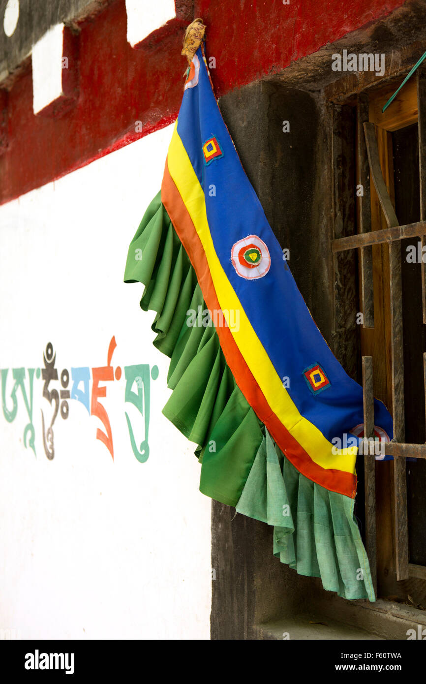 India, Himachal Pradesh, Spiti, Kaza, new town, traditional colourful buddhist window textile beside Spitian Tibetan script Stock Photo