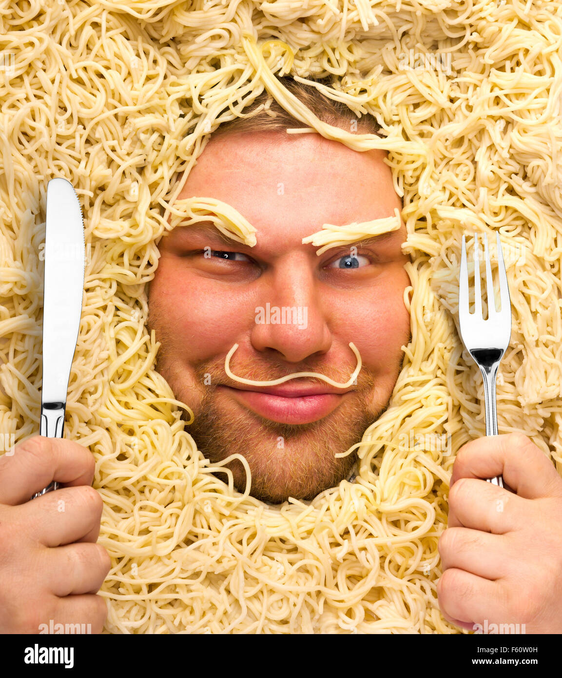 Funny man with fork and knife in pasta Stock Photo Alamy