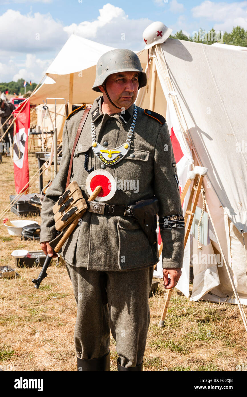 WW2 re-enactment. German military Policeman, Feldgendarmerie, standing,  facing. Wearing a gorget, breast plate, and a stop sign tucked in his belt  Stock Photo - Alamy