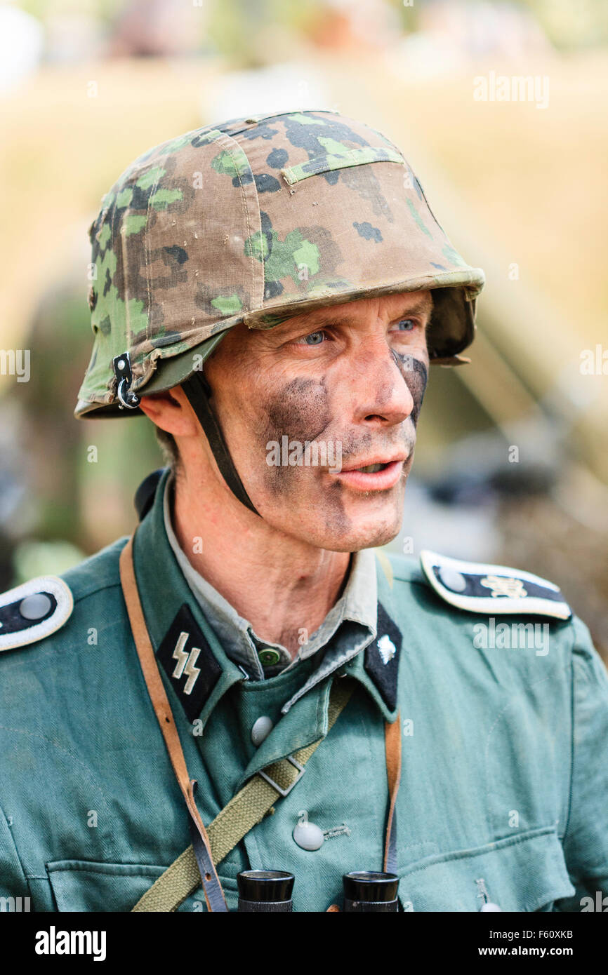 WW2 Re-enactment. German Waffen SS officer, portrait. Close up, head and shoulders. SS insignia on lapel. Black camouflage paint on face. Stock Photo