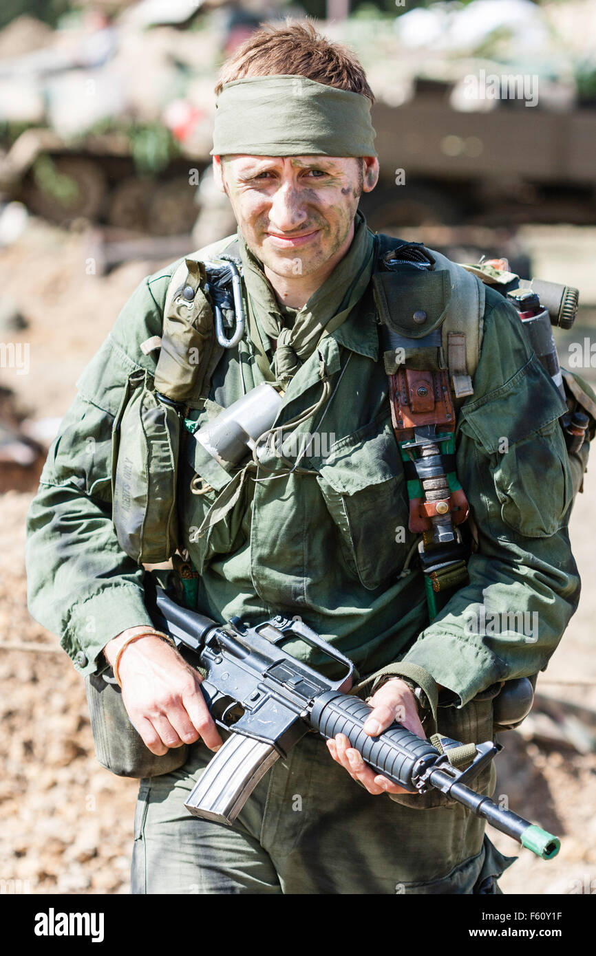 Vietnam war re-enactment, MACV-SOG special operations soldier wearing  bandana headband and holding assault rifle in hands. Facing, eye-contact  Stock Photo - Alamy